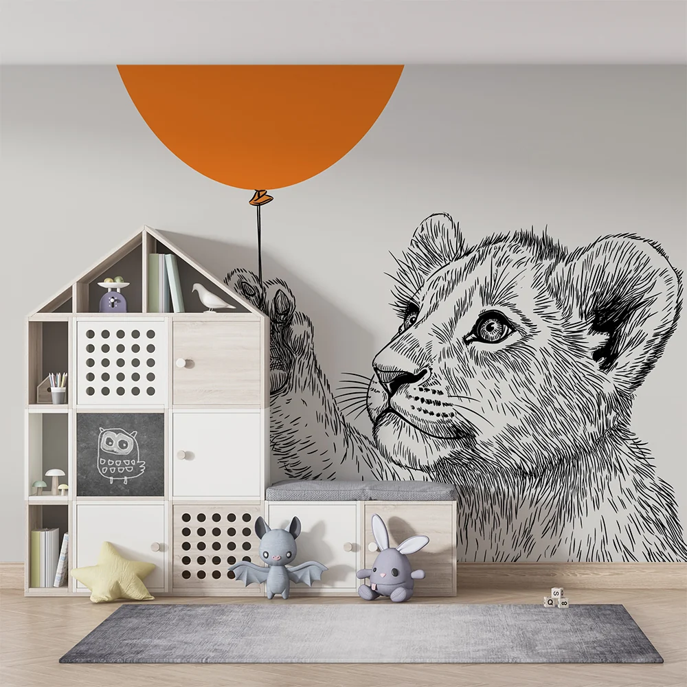 Barnetapet med liten løve og oransje ballong