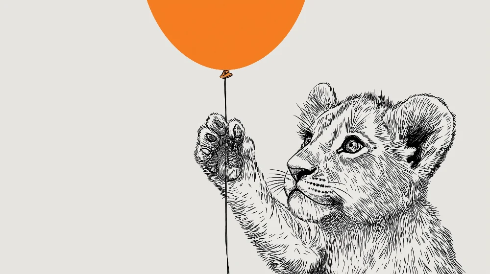 Barnetapet med liten løve og oransje ballong